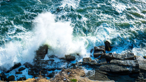 View of waves breaking on rocks