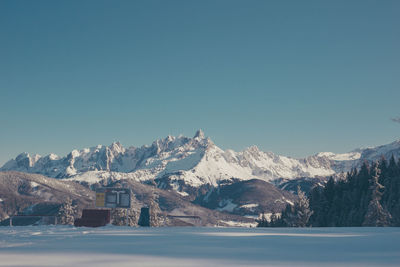 Scenic view of snowcapped mountains against clear blue sky