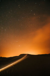 Scenic view of silhouette landscape against sky at night