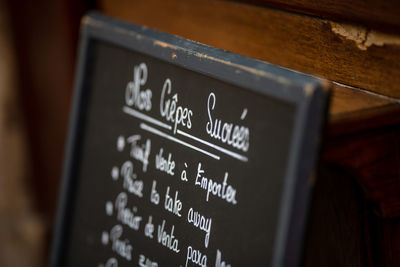 Close-up of information sign board in restaurant