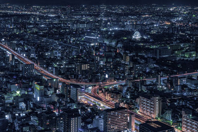 High angle view of city lit up at night