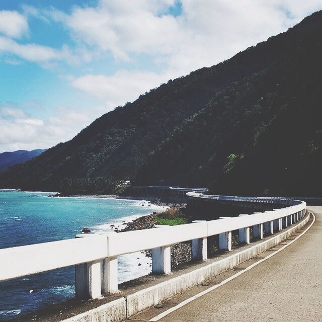 mountain, water, sky, sea, mountain range, transportation, tranquil scene, tranquility, scenics, railing, beauty in nature, nature, cloud - sky, lake, road, river, blue, day, outdoors, cloud