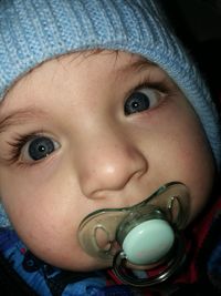 Close-up of baby boy with pacifier in mouth