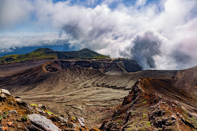 Smoke emitting from volcanic mountain against sky