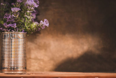 Close-up of flowering plant in jar on table