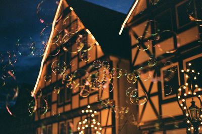 Low angle view of illuminated christmas tree at night