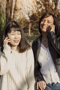 Close-up of colleague talking on phone outdoors