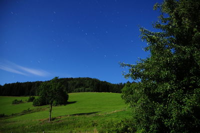 Scenic view of landscape against star field