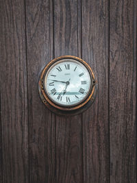 Close-up of clock on wood