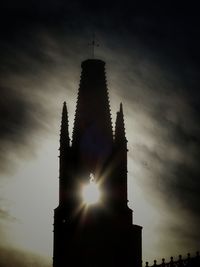 Low angle view of silhouette building against sky during sunset