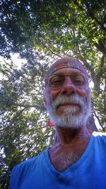 Low angle view of man standing on tree