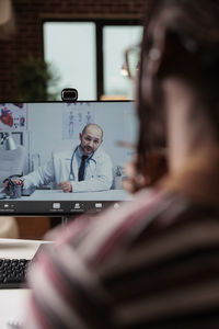 Cropped image of man using laptop