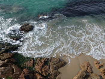 High angle view of waves on shore against sky