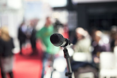 Close-up of microphone against crowd