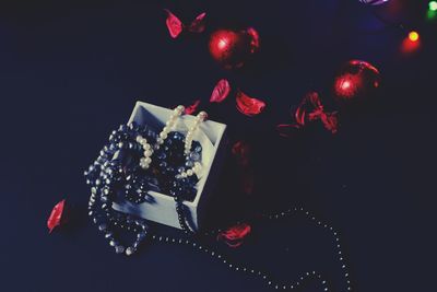 Close-up of illuminated christmas lights against black background