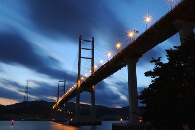 Low angle view of bridge against sky at night