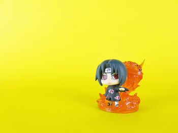 Close-up of toy against yellow background