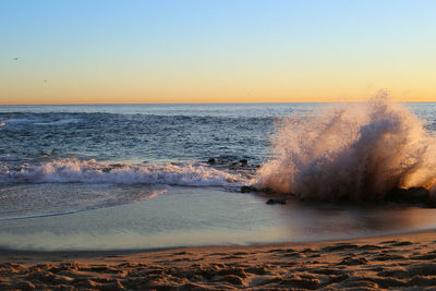 Scenic view of sea against clear sky during sunset