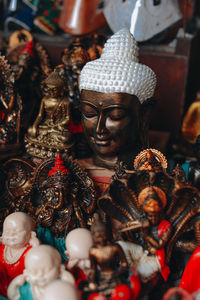 Handmade gold plated buddha face masks on a counter in a street shop on the island of bali