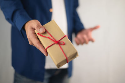 Close-up of human hand holding paper