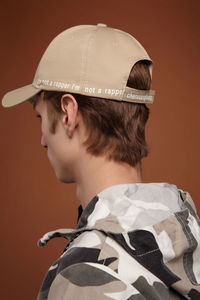 Portrait of boy wearing hat against gray background