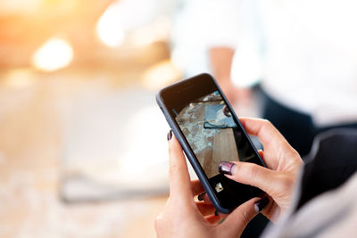 Close-up of hand using mobile phone