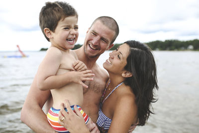 Family laughing by sea