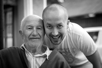 Close-up portrait of cheerful grandfather with grandson