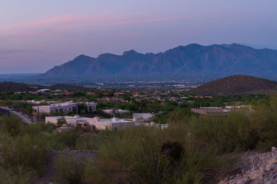 High angle view of townscape and mountains against sky