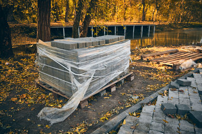 Stack of paving stones against tree