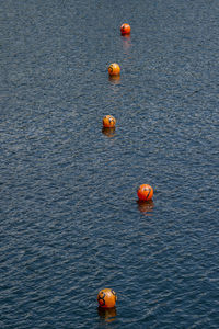 High angle view of buoys in lake