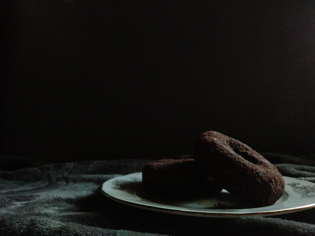 darkness, black, food and drink, food, light, chocolate, sweet food, plate, baked, still life photography, indoors, dessert, dark, sweet, table, no people, freshness, macro photography, cake, copy space, black background, night, still life, temptation, close-up