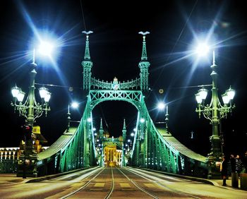 Illuminated bridge at night