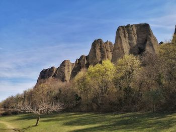 Rock formations on landscape against sky