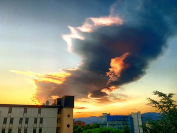 Low angle view of buildings against sky at sunset