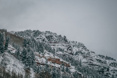 Rocky mountainside peeking out from the fog.