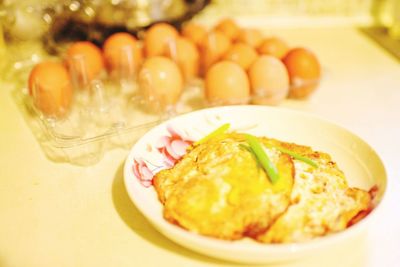 Close-up of fried eggs in plate on table