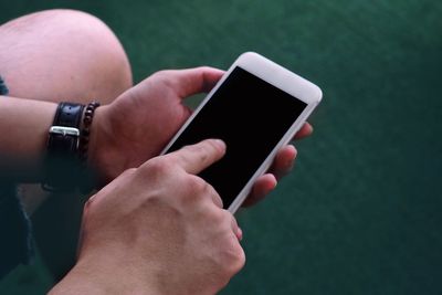 Midsection of man using mobile phone