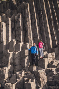 Rear view of people walking on rocks