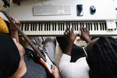 High angle view of males working on music