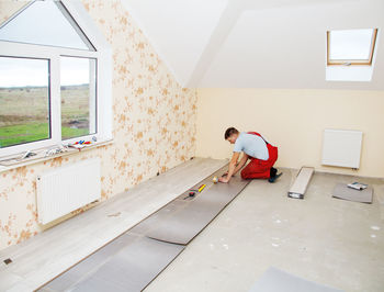 Carpenter working in incomplete home