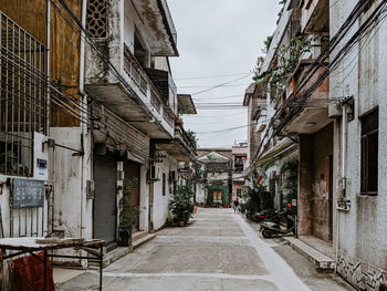 Narrow street amidst buildings against sky