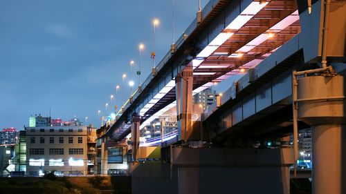 Low angle view of illuminated buildings against sky in city