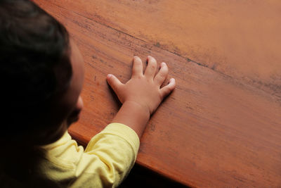 High angle view of baby boy on hardwood floor