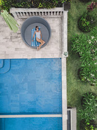 Aerial view of attractive woman near the pool at resort