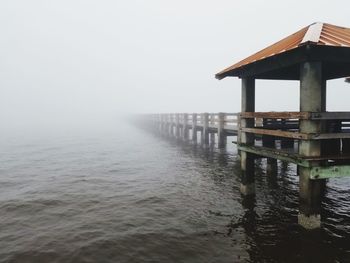 Pier on sea against sky