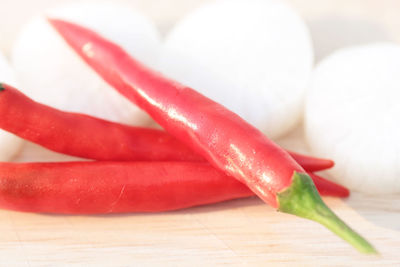 Close-up of red chili peppers on cutting board