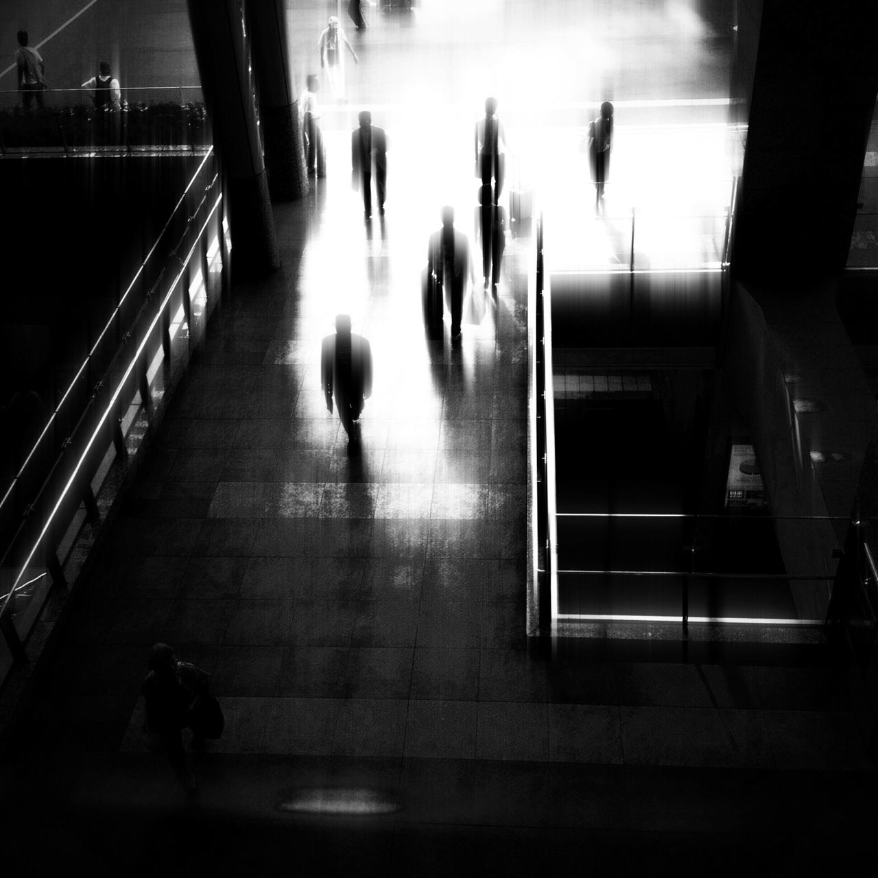 indoors, men, lifestyles, person, large group of people, illuminated, silhouette, medium group of people, leisure activity, walking, night, city life, transportation, group of people, travel, on the move, glass - material, reflection, passenger
