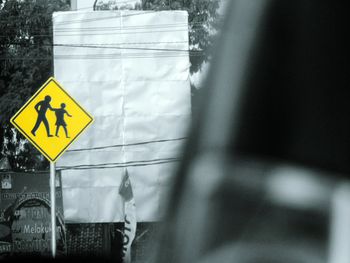 Close-up of road sign against blurred background