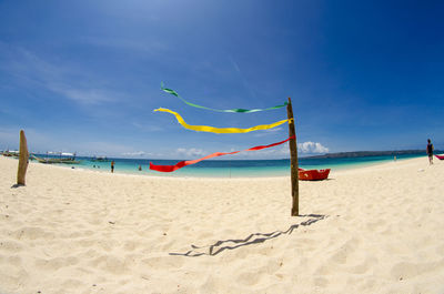 Scenic view of beach against blue sky